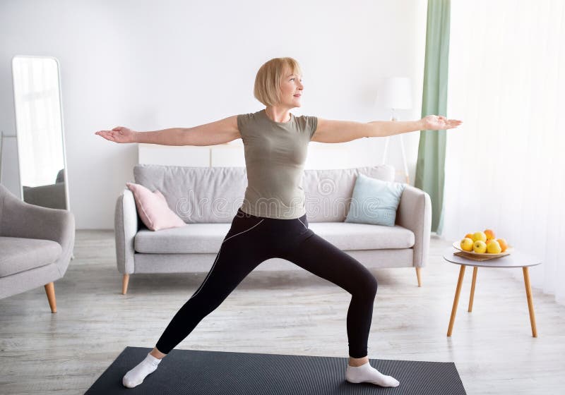 Senior woman doing balance exercise at home